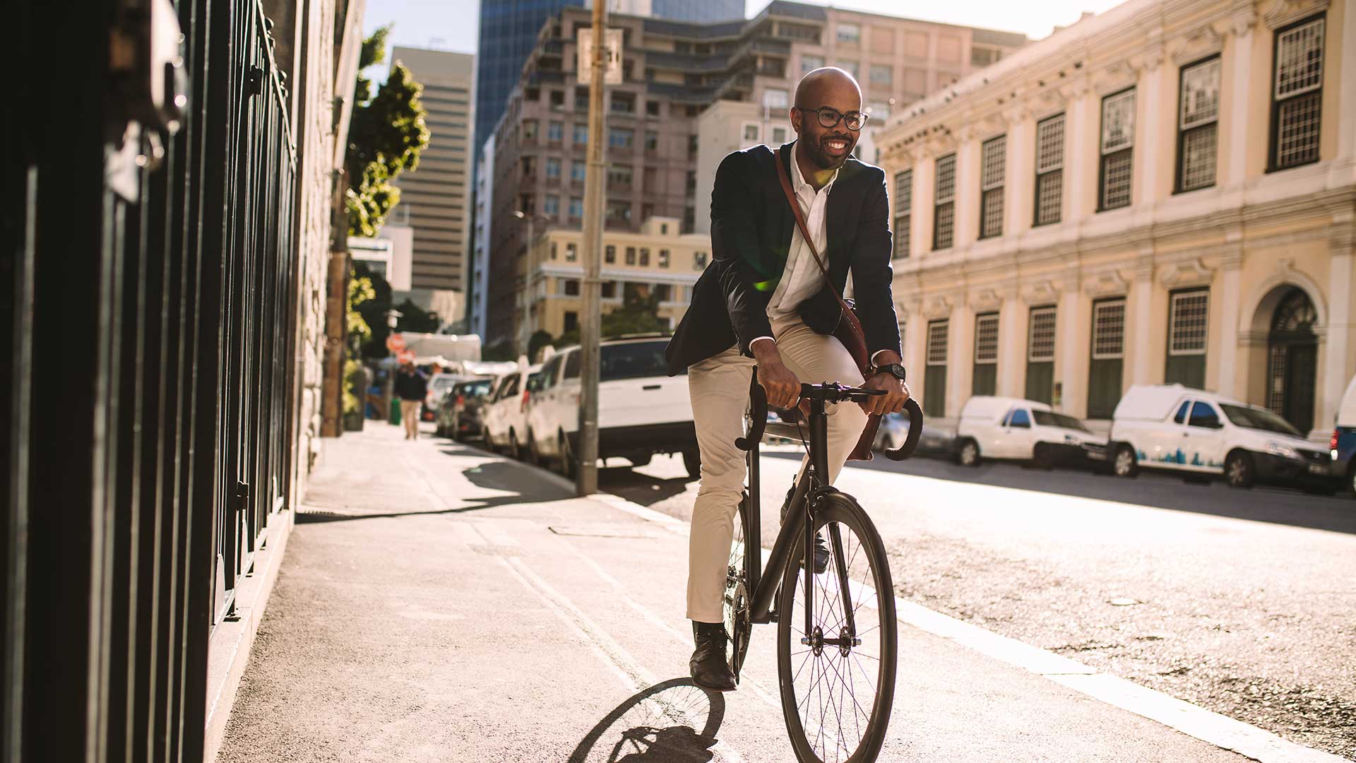 A man riding a bicycle down a city street.