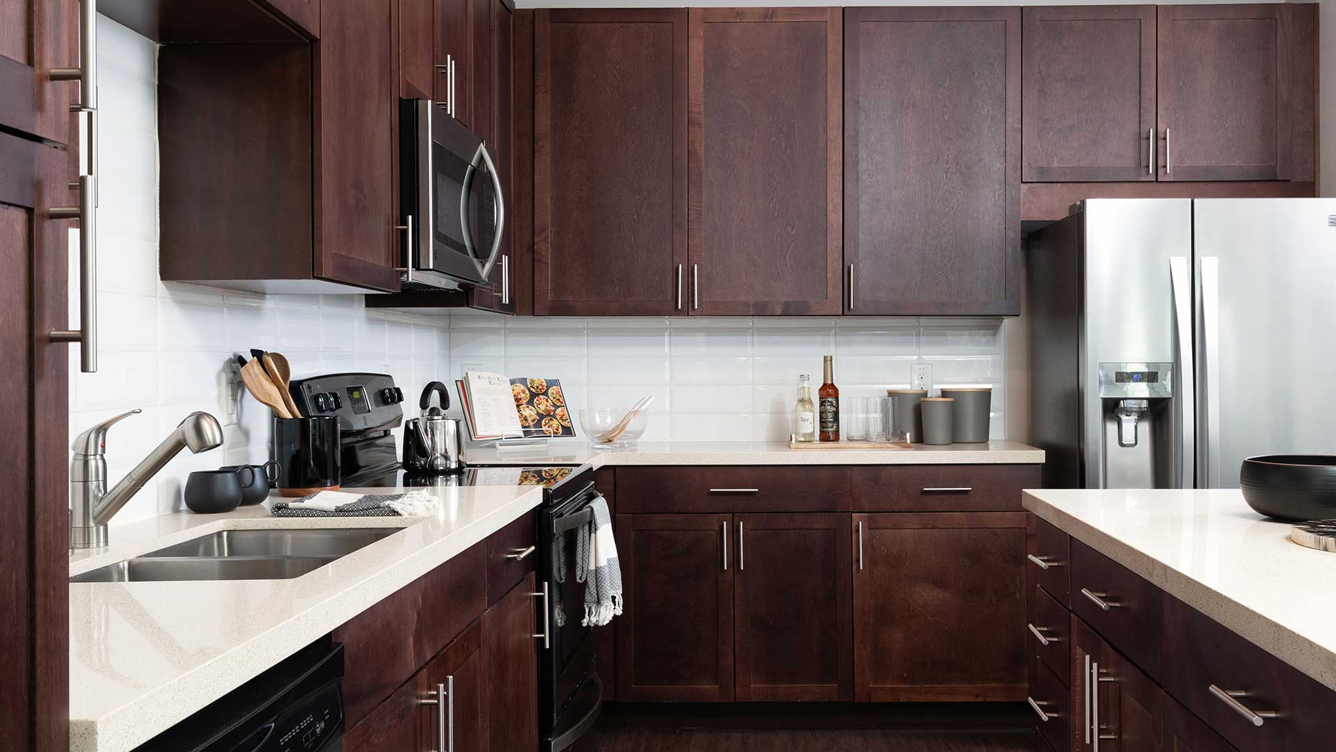 A kitchen with brown cabinets and stainless steel appliances.